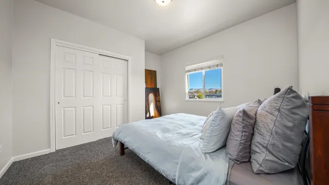 a bedroom with a bed and a window