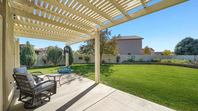 a view of a patio with a table chairs and a swimming pool