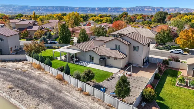 an aerial view of multiple houses with a yard