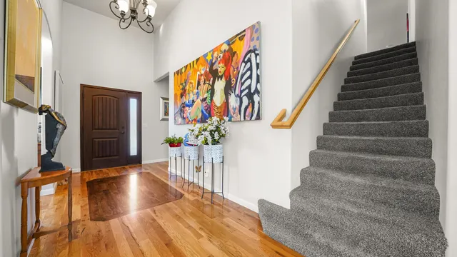 a view of entryway with wooden floor and stairs