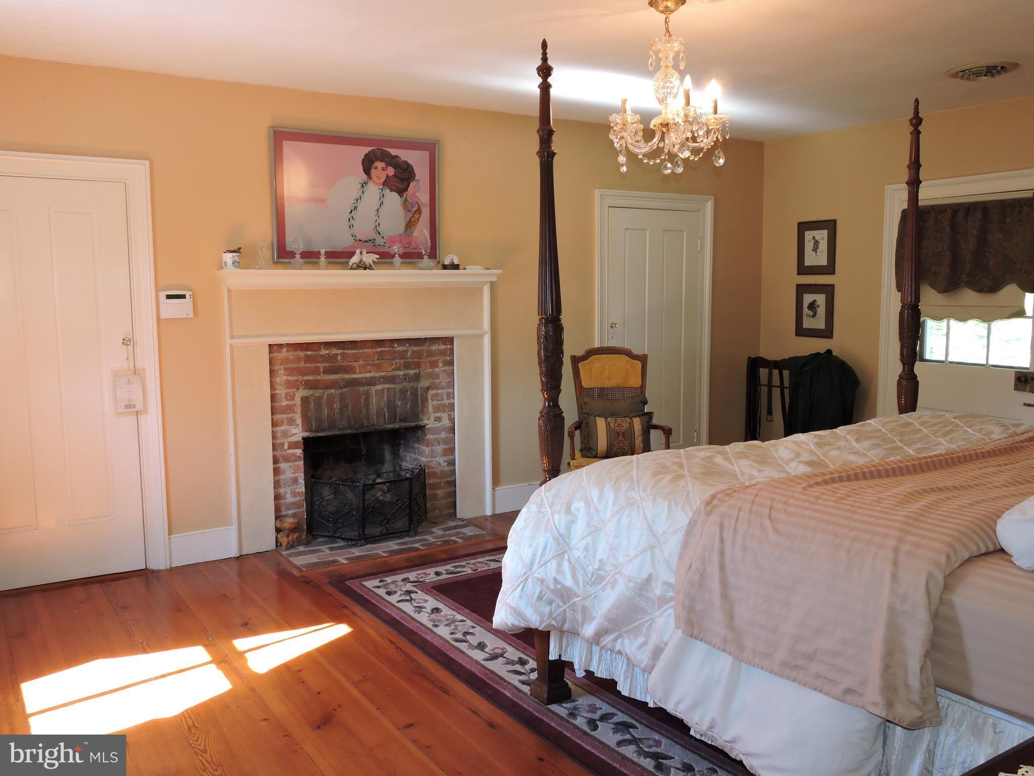 3047 Kabletown Road Charles Town, WV 25414 - Photo 15 of 30 a bedroom with a bed and a fireplace