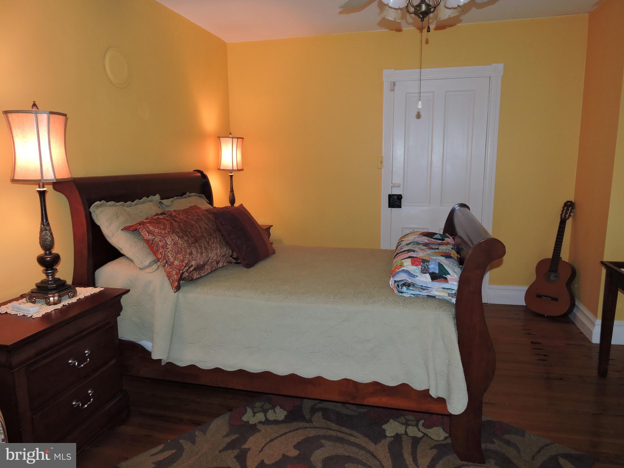 3047 Kabletown Road Charles Town, WV 25414 - Photo 16 of 30 a bedroom with a bed and wooden floor