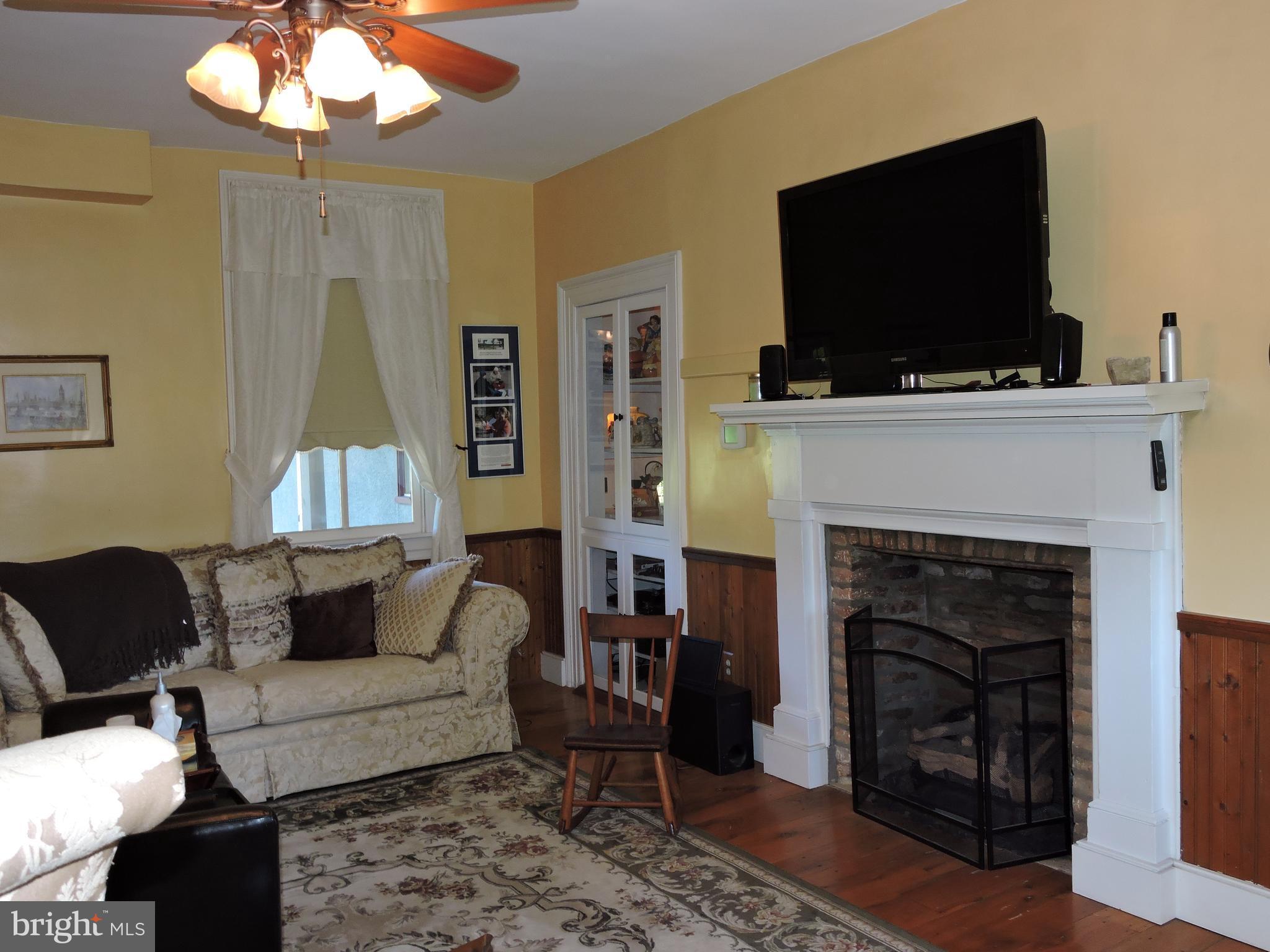 3047 Kabletown Road Charles Town, WV 25414 - Photo 8 of 30 a living room with furniture a flat screen tv and a fireplace