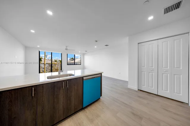 a kitchen with stainless steel appliances granite countertop a sink and cabinets