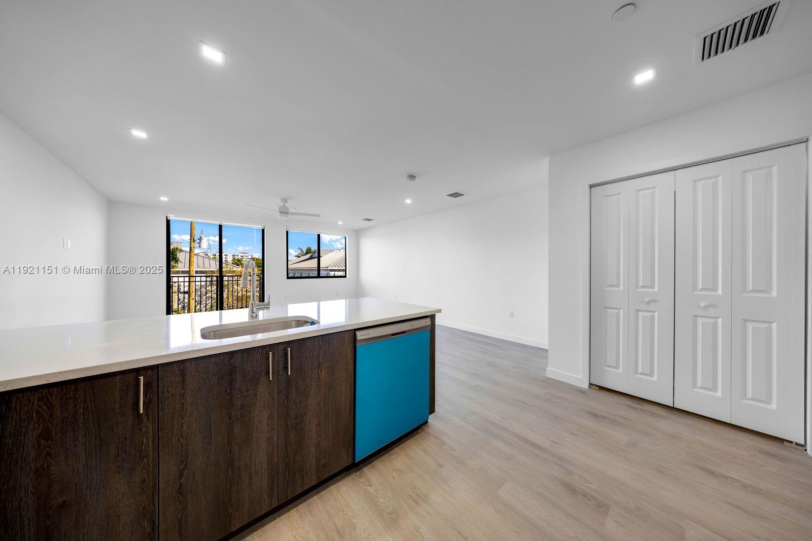 20 Northeast 19th Avenue, Unit 210 Pompano Beach, FL 33060 - Photo 2 of 18 a kitchen with stainless steel appliances granite countertop a sink and cabinets