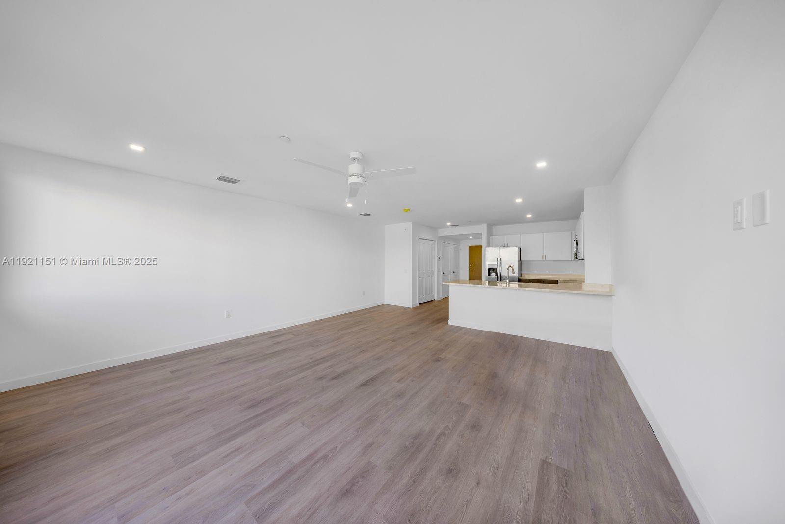 20 Northeast 19th Avenue, Unit 210 Pompano Beach, FL 33060 - Photo 7 of 18 a view of empty room with wooden floor