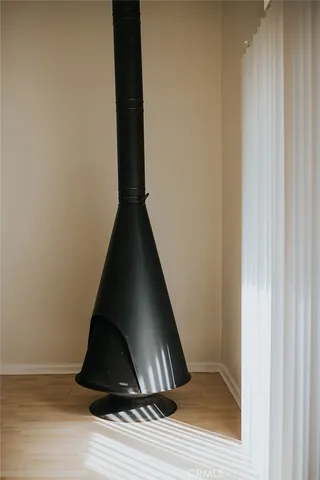 a view of a kitchen with wooden floor and electronic appliances