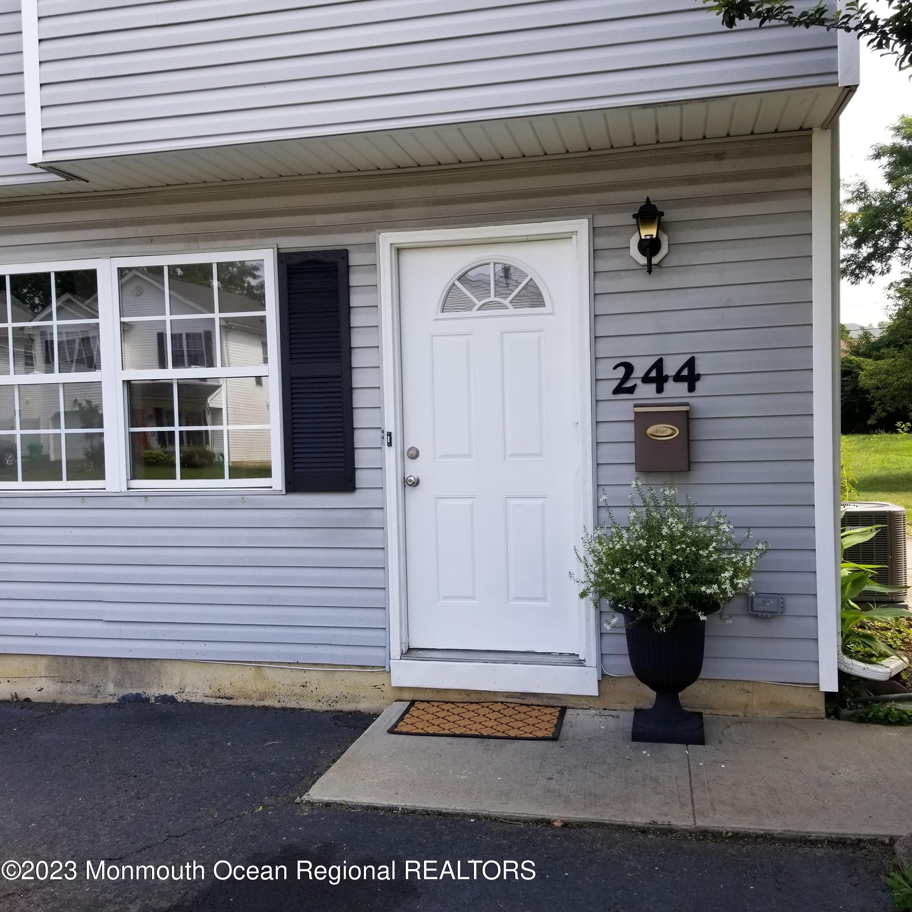 244 Raritan Street Keyport, NJ 07735 - Photo 2 of 20 a potted plant sitting in front of a house