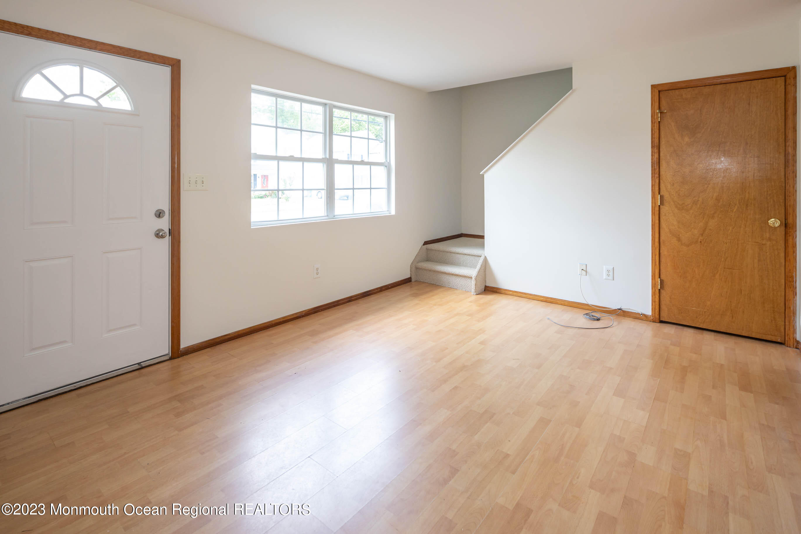 244 Raritan Street Keyport, NJ 07735 - Photo 3 of 20 an empty room with wooden floor and windows