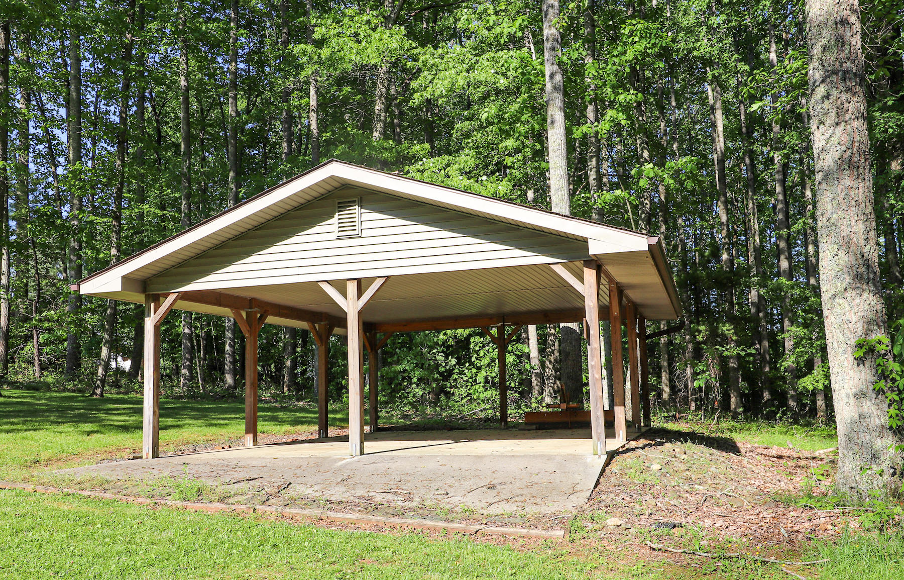 296 Kyle Weeks Road Southwest Willis, VA 24380 - Photo 28 of 35 a backyard of a house with table and chairs under an umbrella