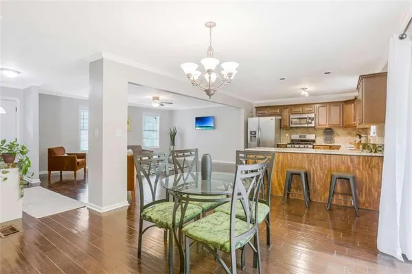 a view of a dining room with furniture and wooden floor