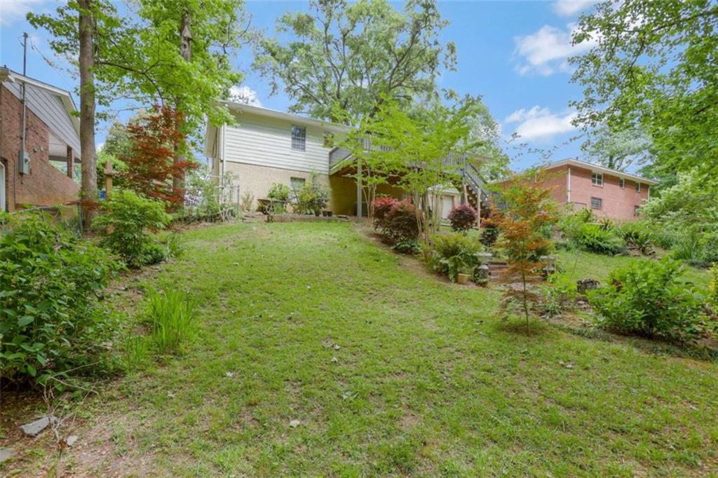 3211 Flamingo Drive East Point, GA 30344 - Photo 24 of 24 a backyard of a house with plants and large trees