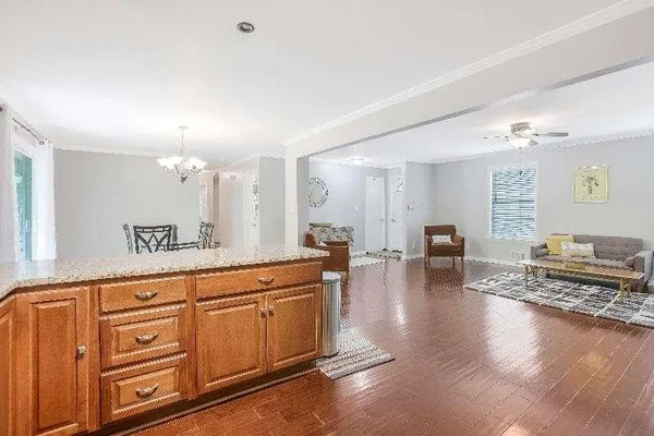 a spacious bathroom with stainless steel appliances granite countertop a stove and a wooden floors