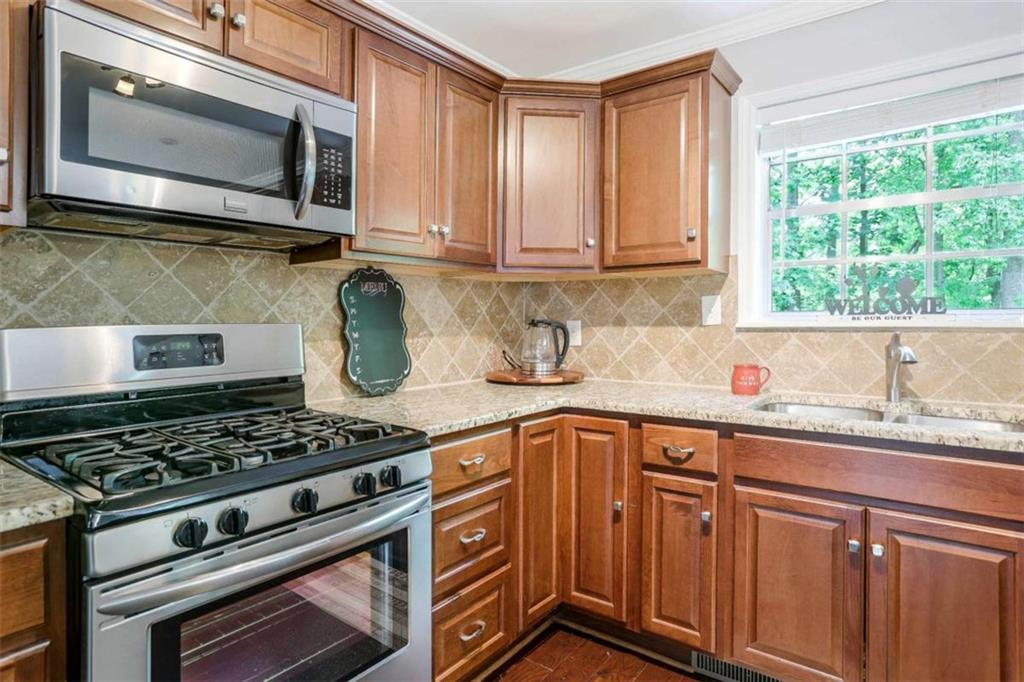 3211 Flamingo Drive East Point, GA 30344 - Photo 8 of 24 a kitchen with stainless steel appliances granite countertop a sink stove and microwave