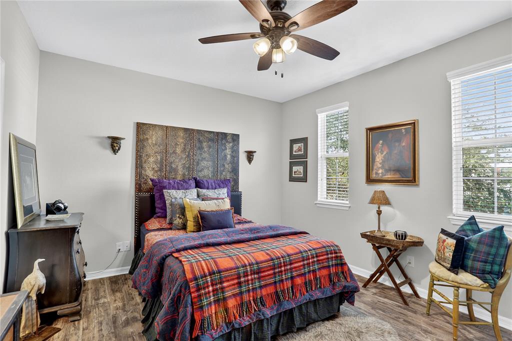 613 Fortanini Circle Ocoee, FL 34761 - Photo 11 of 24 a bedroom with a bed and a chandelier