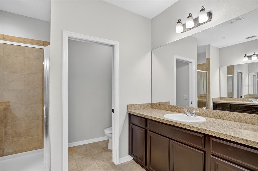 613 Fortanini Circle Ocoee, FL 34761 - Photo 14 of 24 a bathroom with a sink double vanity and a mirror