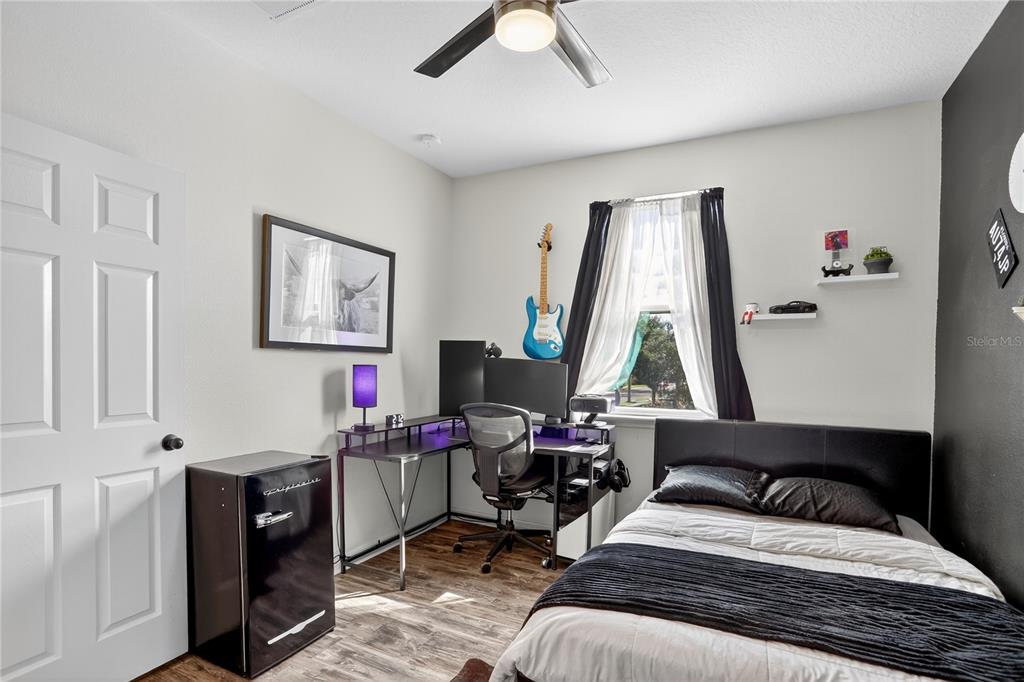 613 Fortanini Circle Ocoee, FL 34761 - Photo 15 of 24 a bedroom with a bed and a window