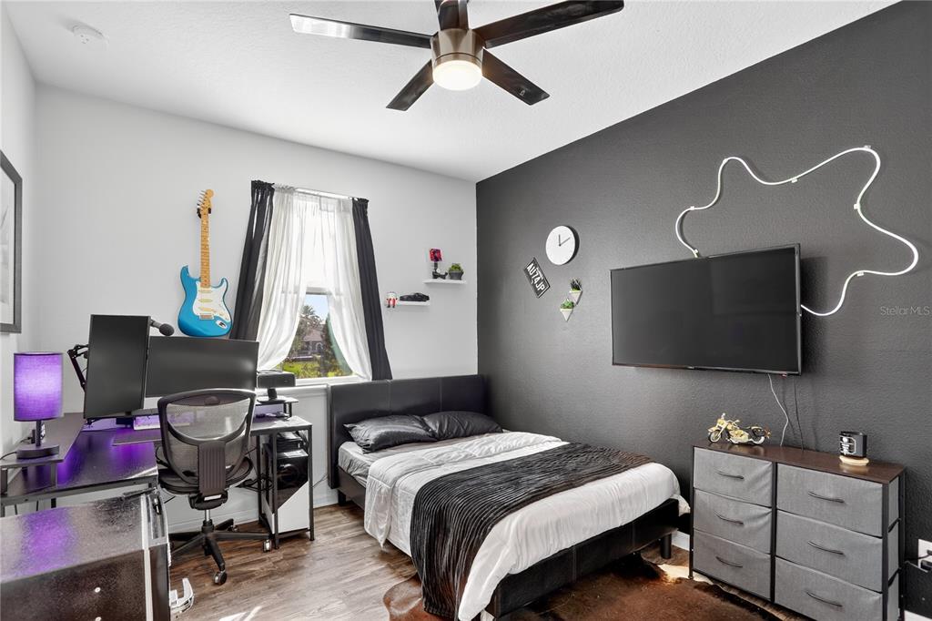 613 Fortanini Circle Ocoee, FL 34761 - Photo 16 of 24 a bedroom with bed and a flat tv screen on the dresser