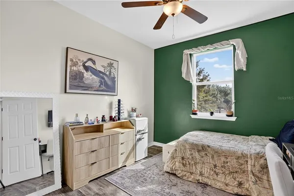 a bedroom with a bed and a window