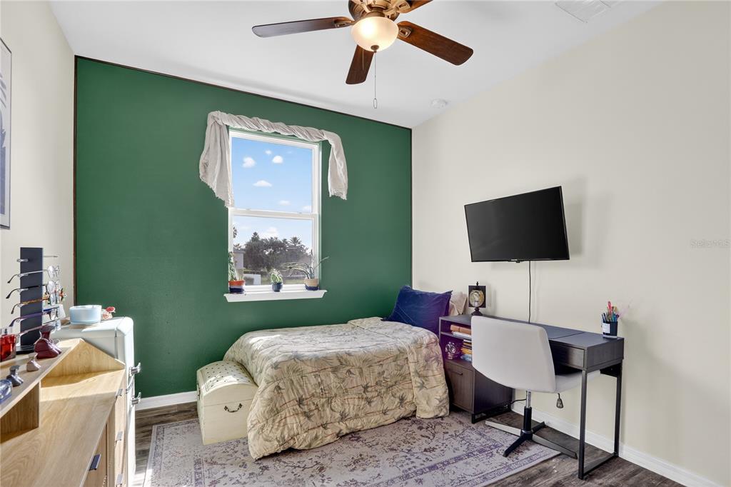 613 Fortanini Circle Ocoee, FL 34761 - Photo 18 of 24 a bedroom with a bed and a flat screen tv