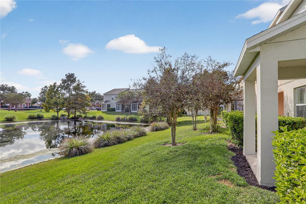 613 Fortanini Circle Ocoee, FL 34761 - Photo 23 of 24 a view of a lake with a yard and a large tree