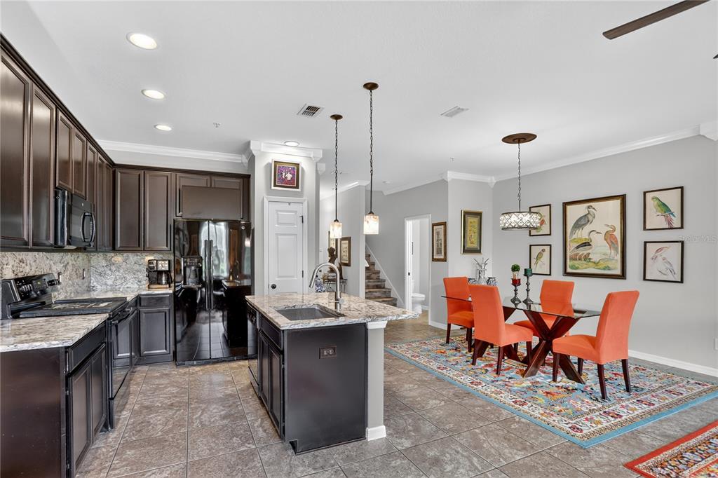 613 Fortanini Circle Ocoee, FL 34761 - Photo 6 of 24 a large kitchen with lots of furniture a sink appliances and cabinets