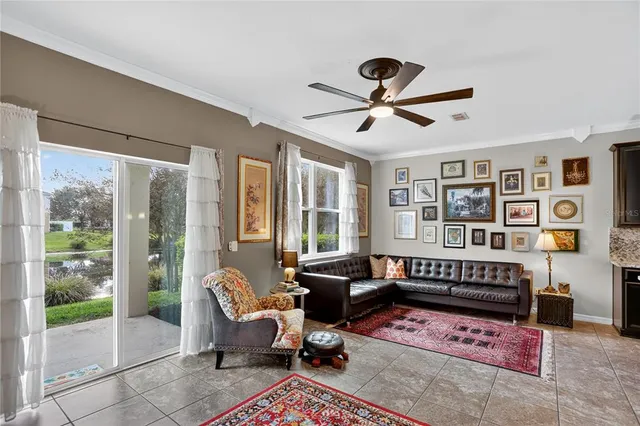 a living room with furniture windows and wooden floor