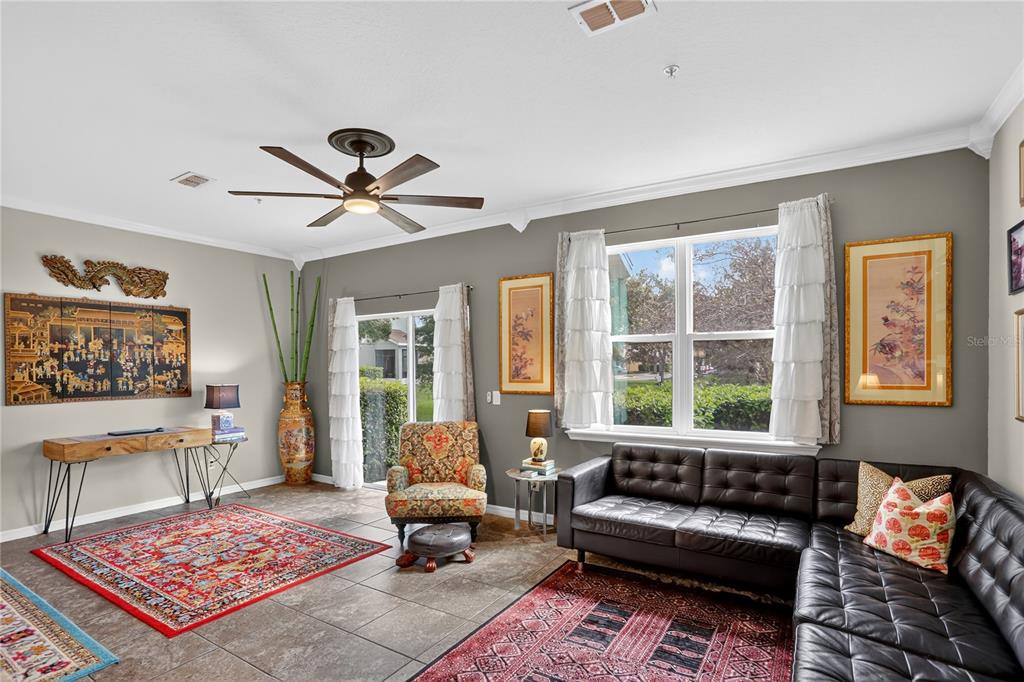613 Fortanini Circle Ocoee, FL 34761 - Photo 8 of 24 a living room with furniture a rug and a large window