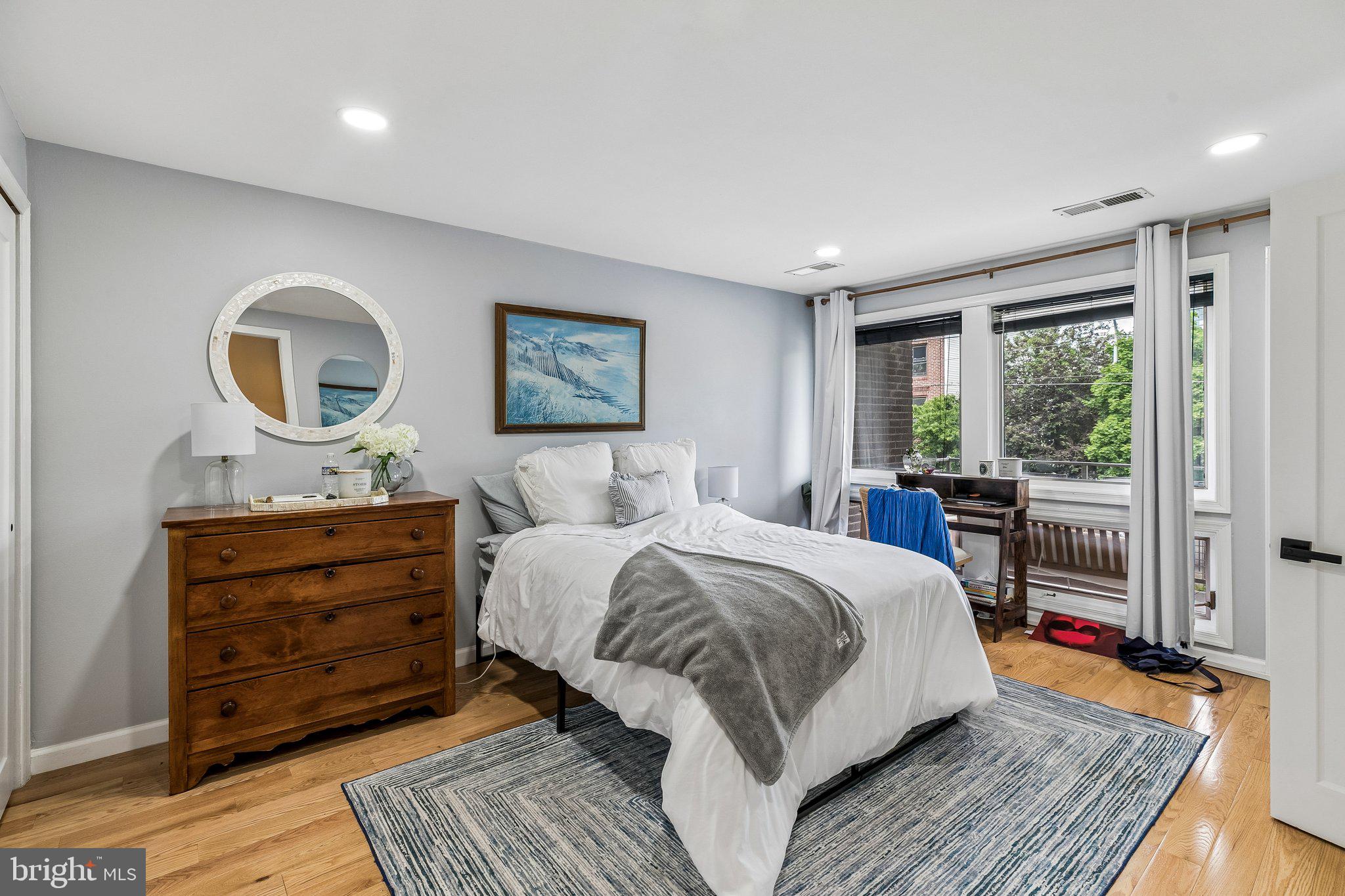 1130 Lombard Street Philadelphia, PA 19147 - Photo 12 of 45 a spacious bedroom with a large bed and a window