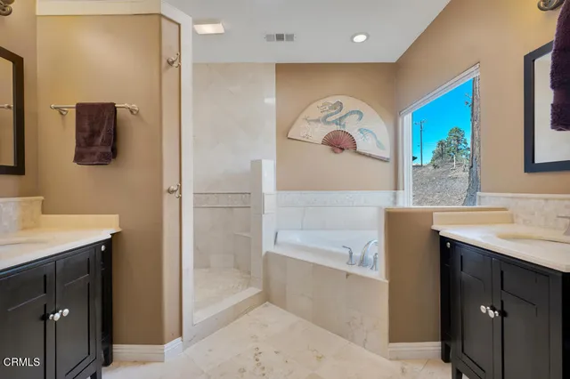 a bathroom with a granite countertop sink mirror vanity and toilet