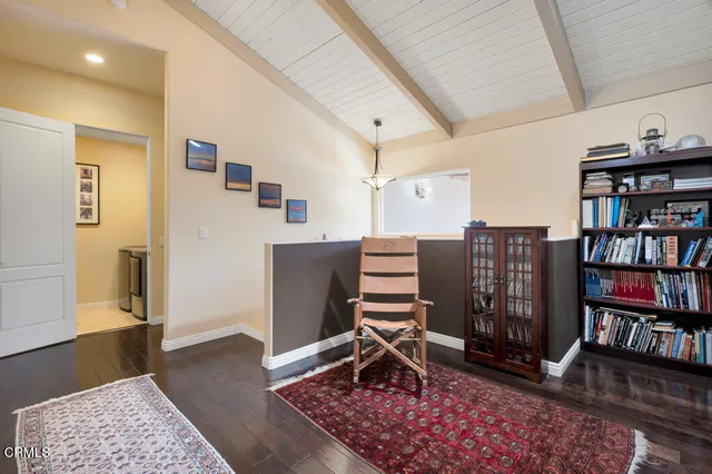 a bedroom with a bed and painting on the wall