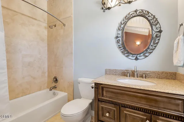 a view of a bedroom with workspace and wooden floor