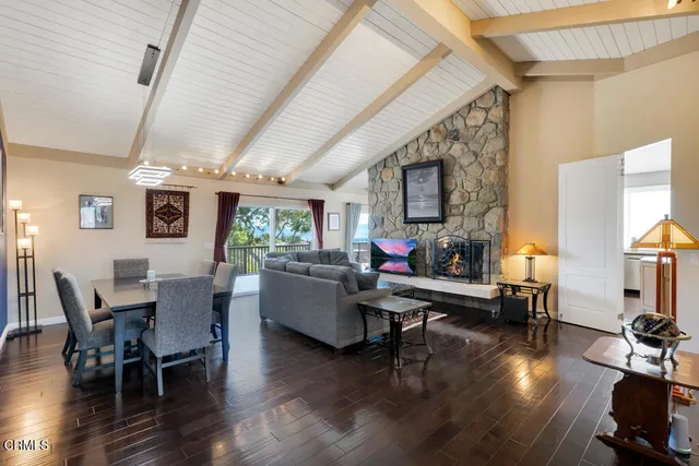 a living room with furniture wooden floor and a flat screen tv