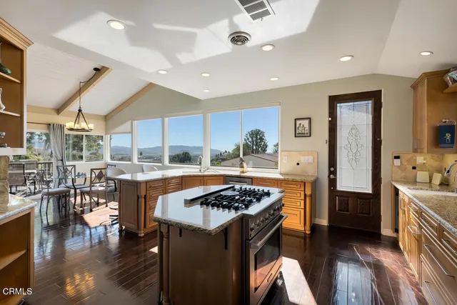 a kitchen with stainless steel appliances granite countertop a stove and a refrigerator
