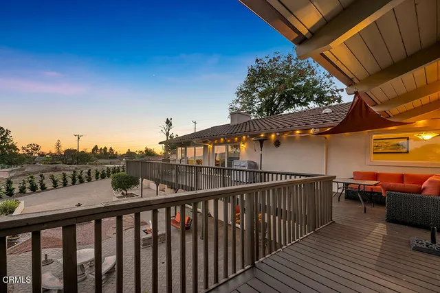 a view of a yard with wooden fence