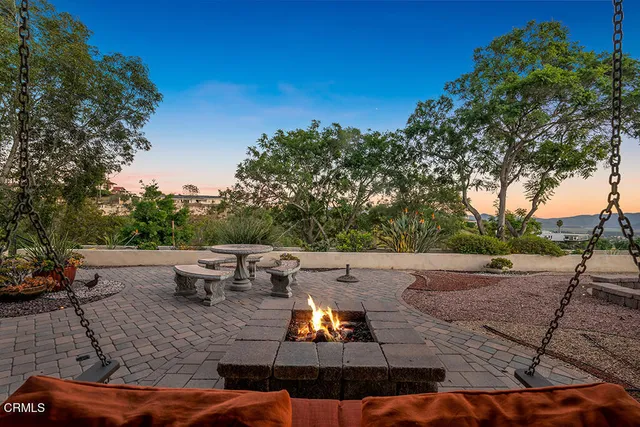 a view of a terrace with couches and sky view