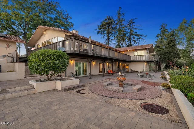 a view of a house with patio and a garden