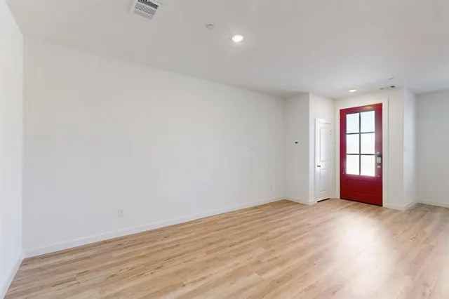 a view of kitchen with cabinets and refrigerator