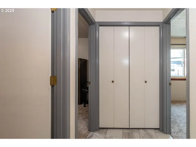 a living room with furniture a large window and a fireplace
