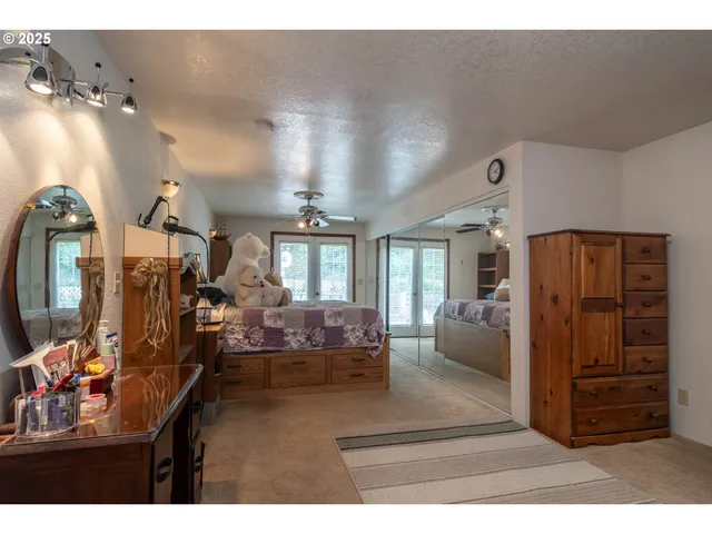 a bathroom with a double vanity sink toilet mirror and shower