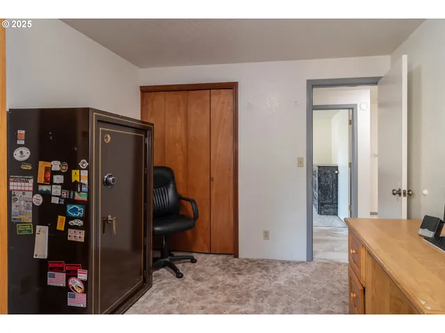 a workspace with furniture and a fan