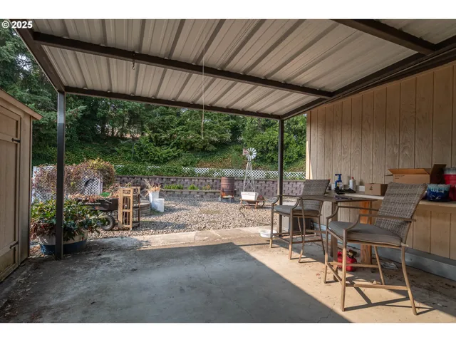 a view of house with backyard and seating space
