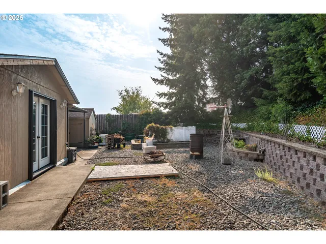 a backyard of a house with table and chairs