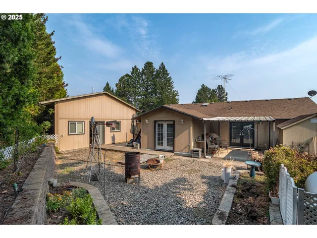 a view of a patio with table and chairs under an umbrella with a patio