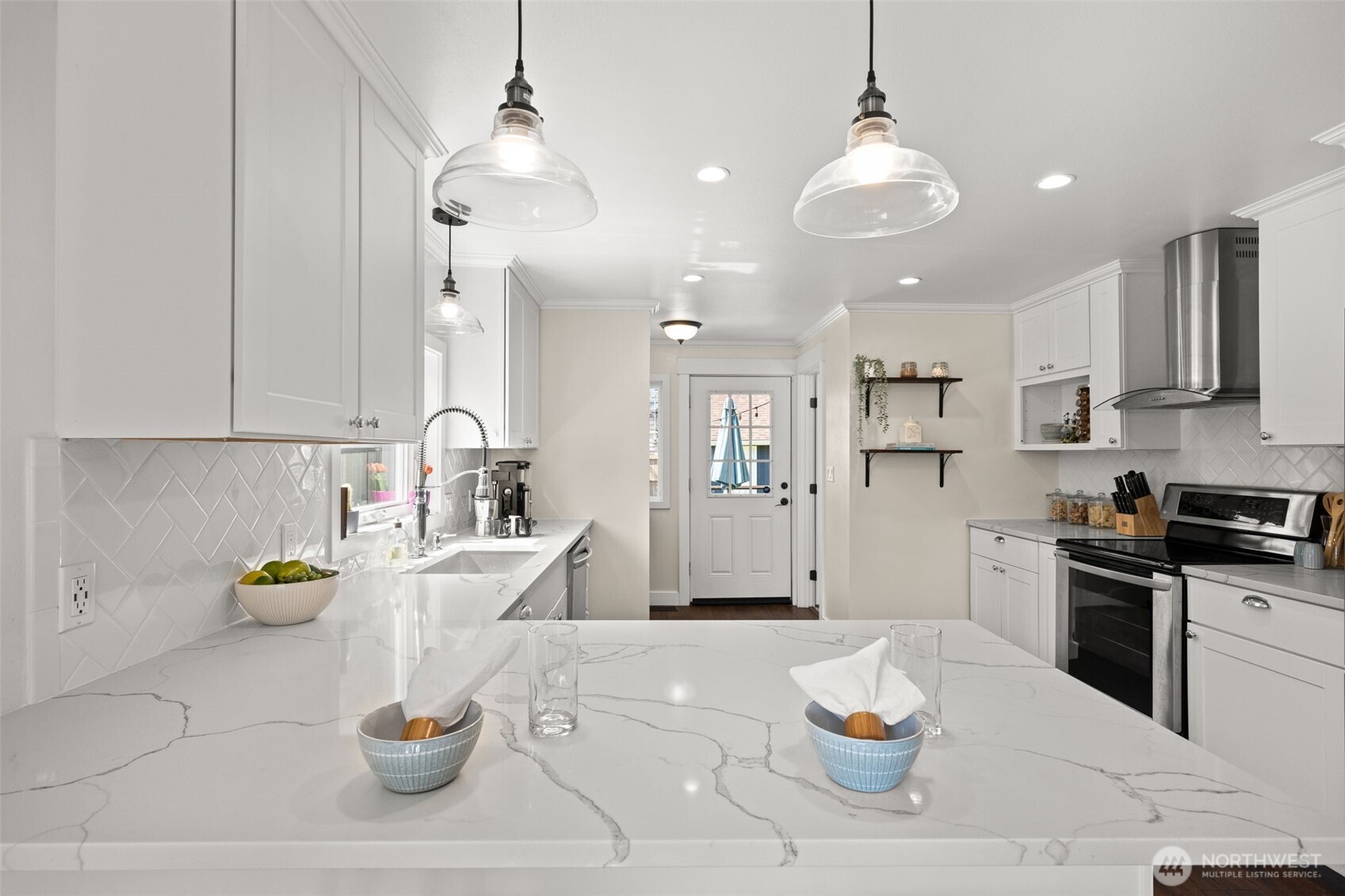 1928 Virginia Avenue Everett, WA 98201 - Photo 11 of 40 a kitchen with white cabinets and stainless steel appliances