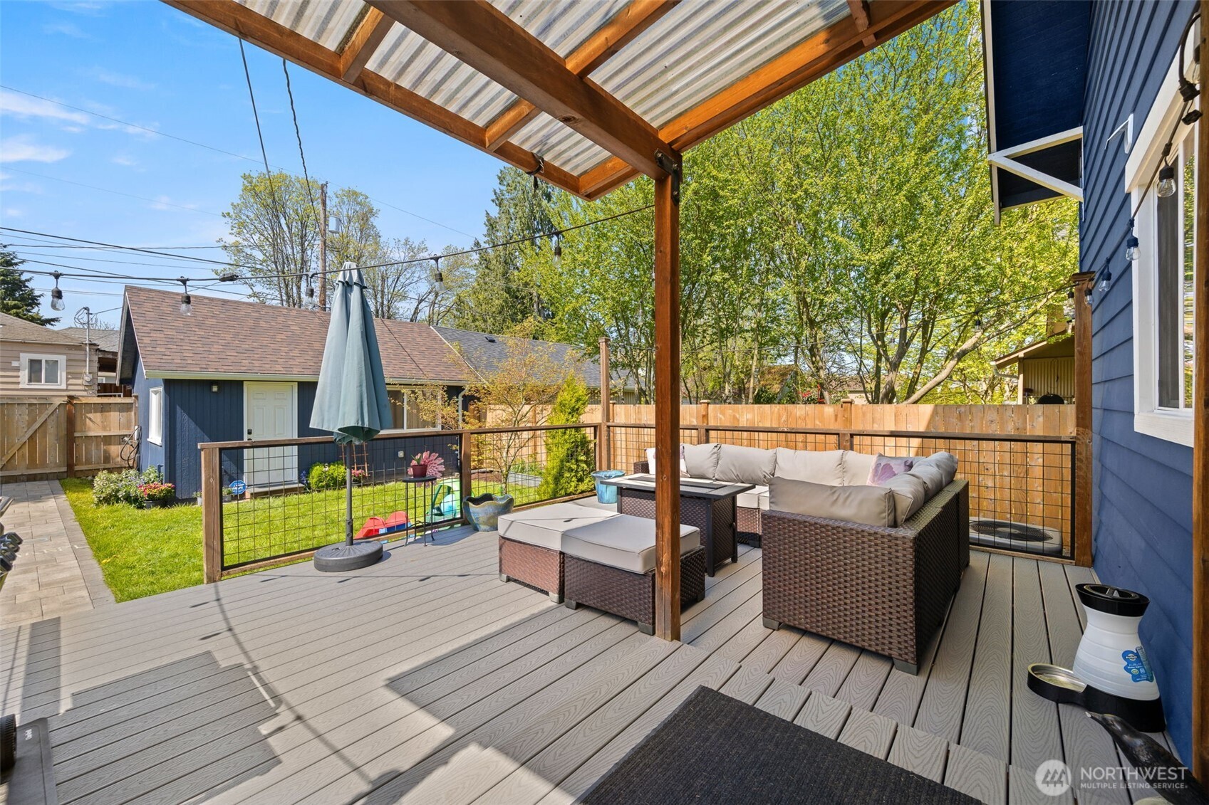1928 Virginia Avenue Everett, WA 98201 - Photo 31 of 40 a view of a deck with couches table and chairs with wooden floor and fence