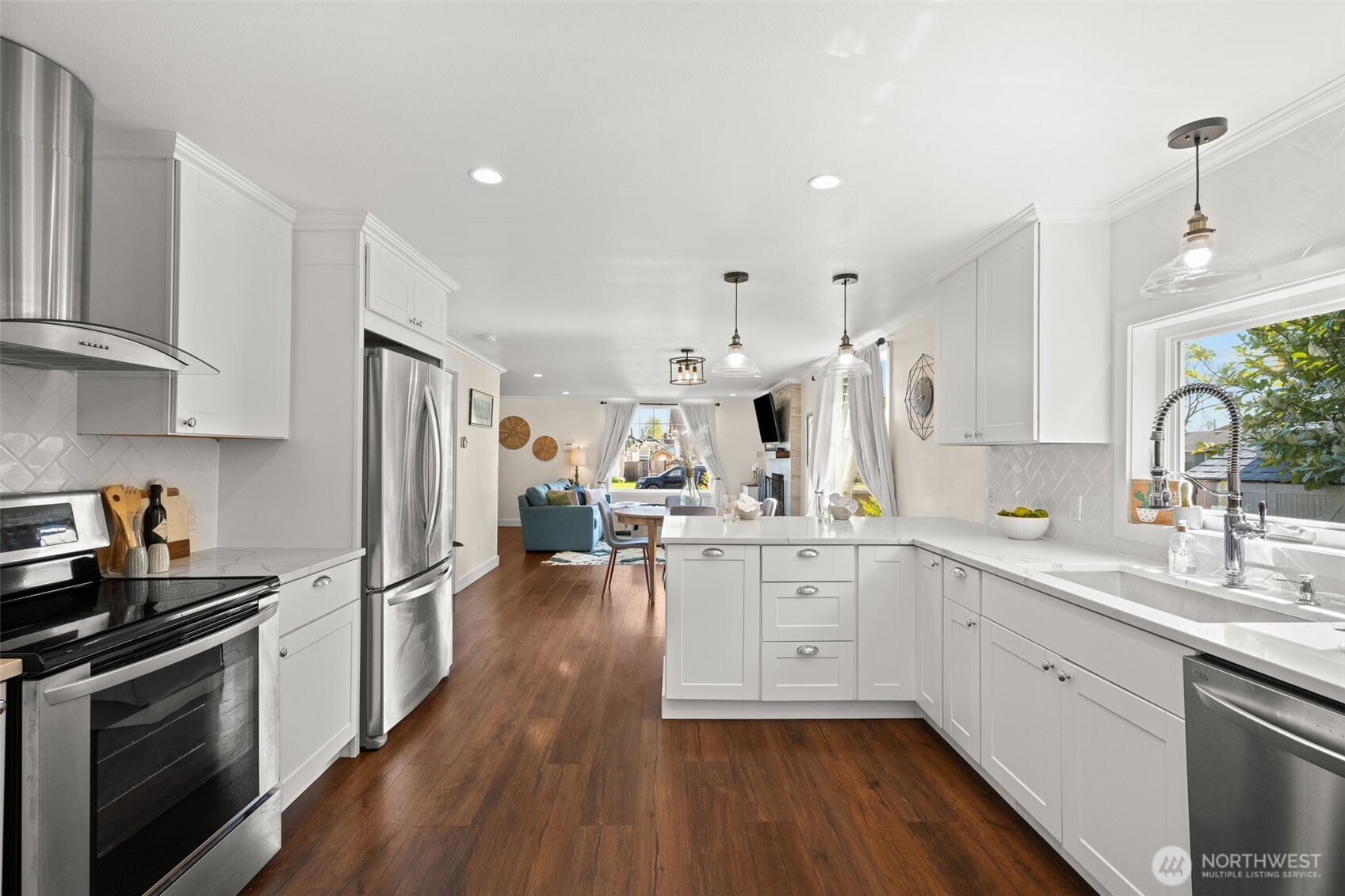 1928 Virginia Avenue Everett, WA 98201 - Photo 9 of 40 a kitchen with white cabinets and stainless steel appliances