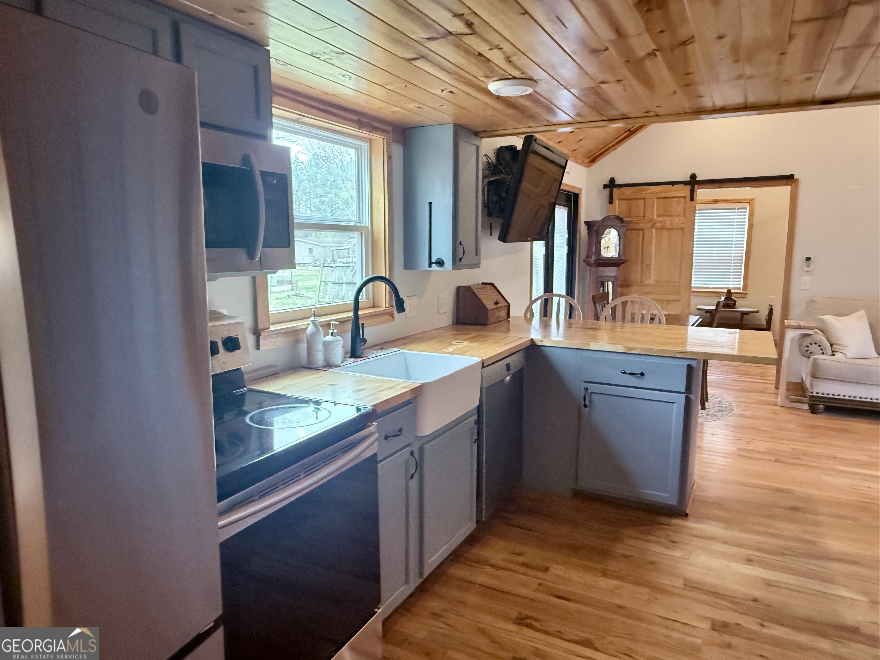 168 Ellenburg Subdivision Summerville, GA 30747 - Photo 19 of 24 a kitchen with kitchen island granite countertop a sink stove and cabinets