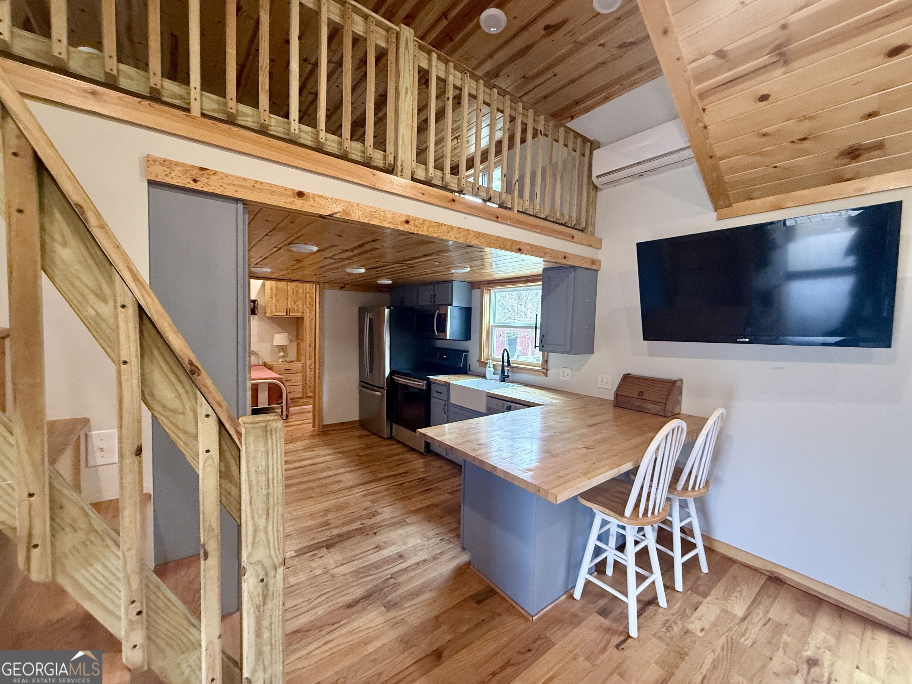 168 Ellenburg Subdivision Summerville, GA 30747 - Photo 4 of 24 a dining room with furniture a flat screen tv and wooden floor