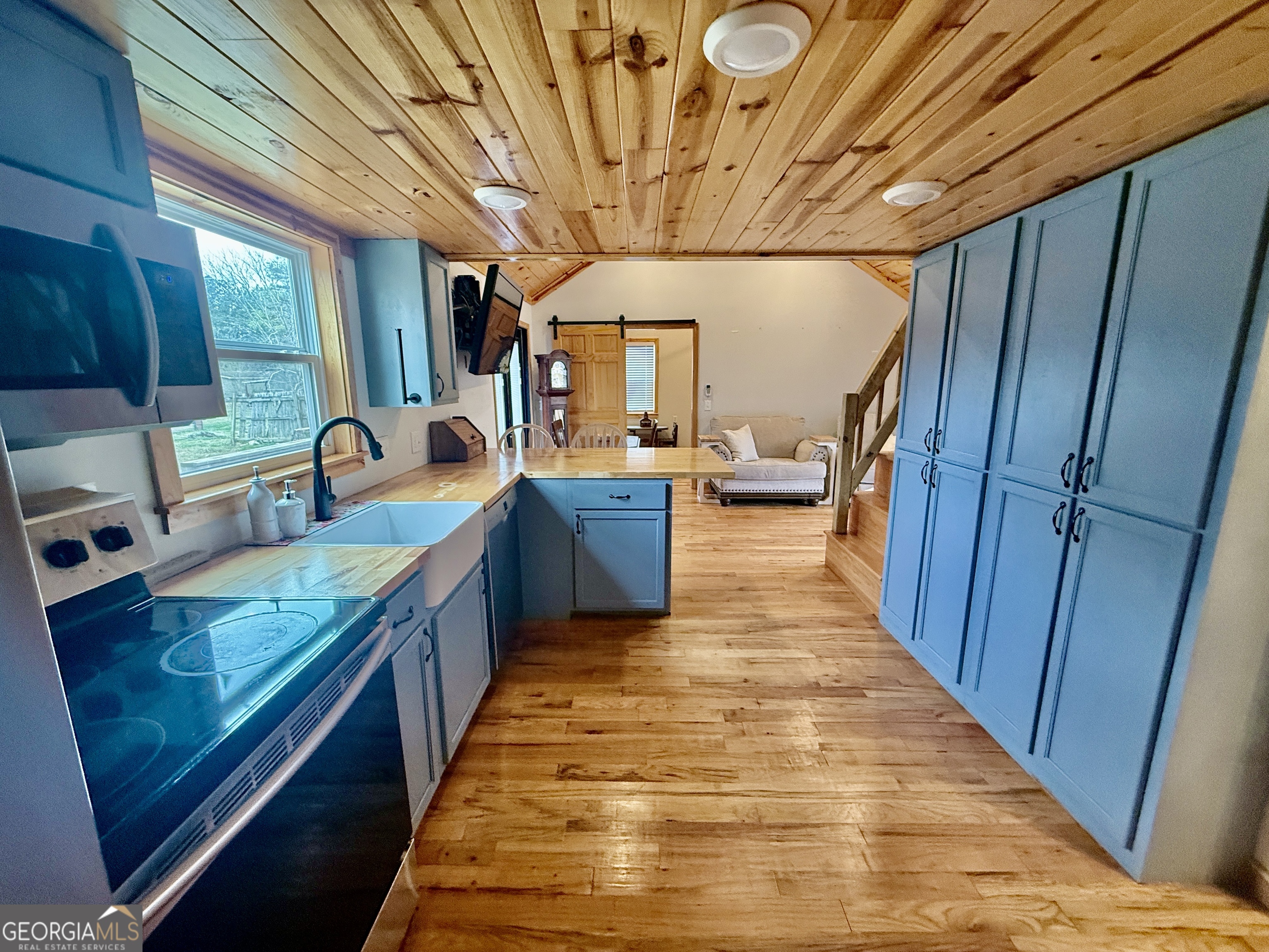 168 Ellenburg Subdivision Summerville, GA 30747 - Photo 7 of 24 a large kitchen with stainless steel appliances wooden floors and wooden cabinets